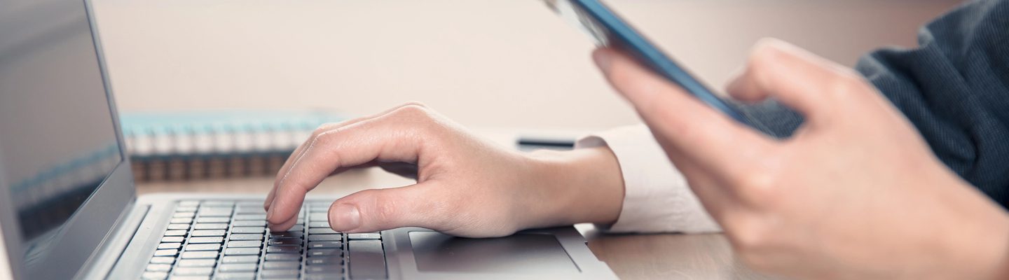 woman working hand phone and computer in office